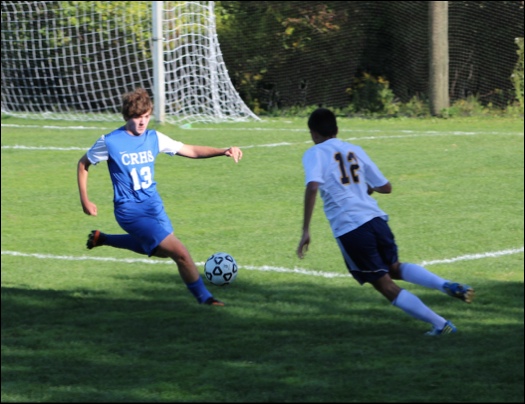 Senior, Jacob Burt, up against a Valley Regional Warriors player, getting ready to kick the ball.