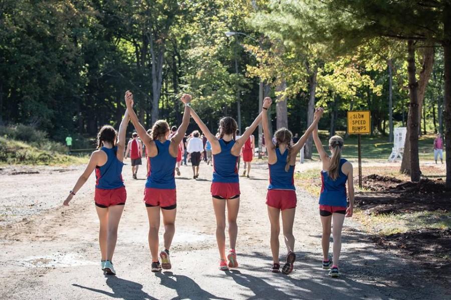 Cross+Country+runners+raise+their+hands+to+a+solid+start+to+the+season.+