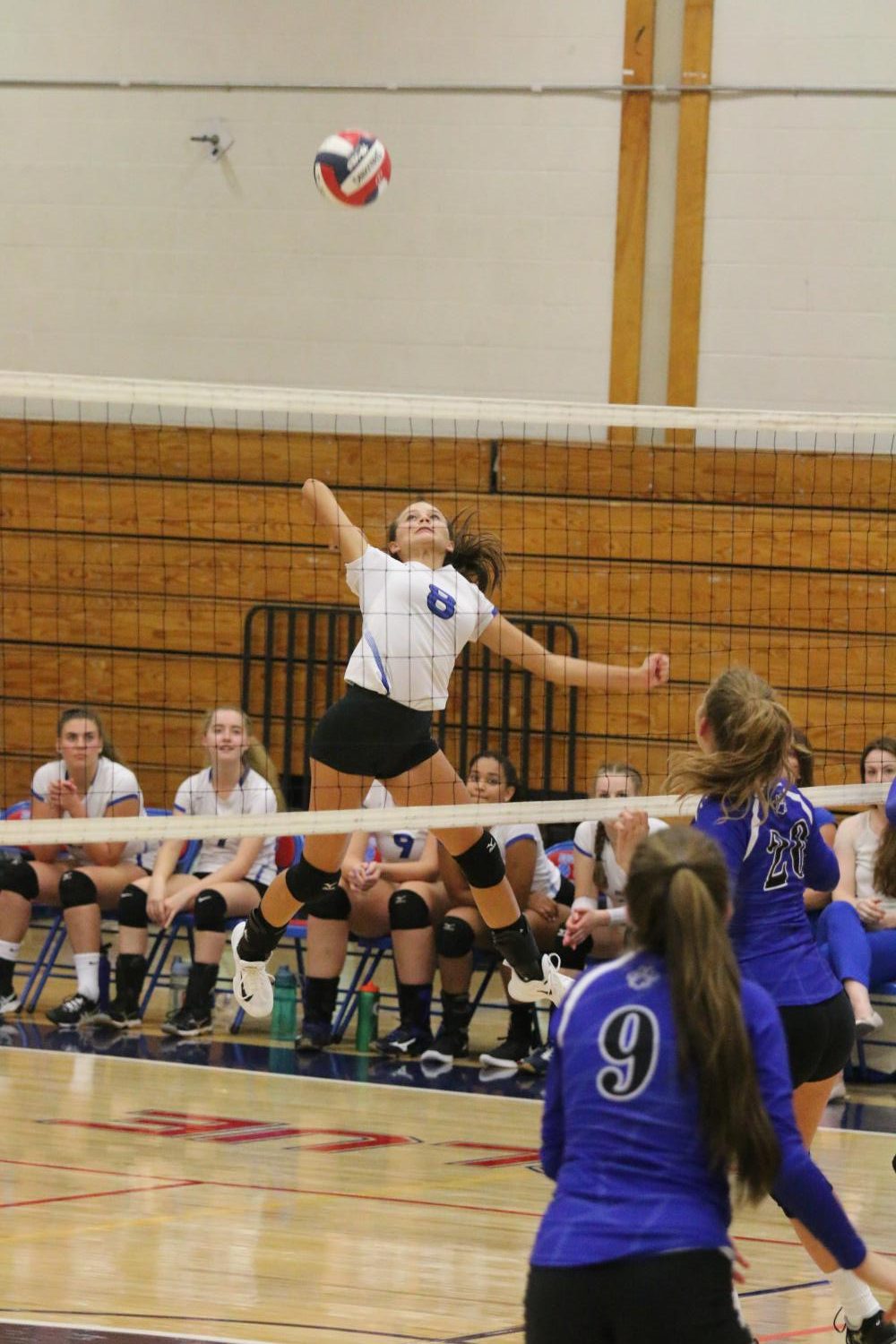 Junior Sydney Fowler leaps for a spike