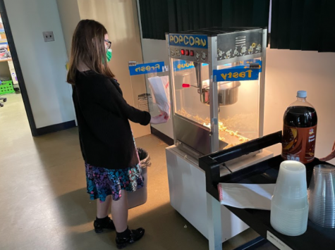 Student gets popcorn from popcorn machine